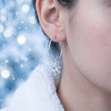 Load image into Gallery viewer, Sterling silver snowflake hoop earrings by MiShelli featuring intricate snowflake designs on classic hoop earrings.