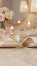 Load image into Gallery viewer, Vintage-inspired Moissanite diamond halo ring in 14K yellow gold, featuring an emerald-cut center stone and intricate detailing.